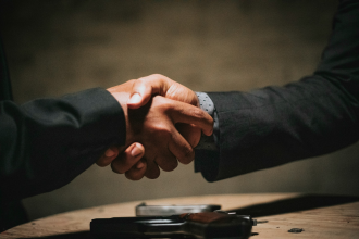 Partnership 1 Two people shaking hands, signaling a successful business transaction.